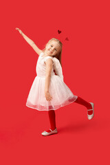 Cute little girl dressed as cupid on red background. Valentine's Day celebration