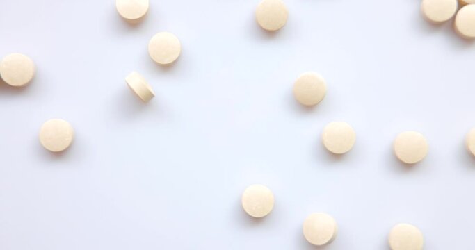 Closeup Top View - a group of pill, and medicine light orange Flying Towards the Camera in Slow Motion in studio. Vitamin supplements for health. Drug addiction. 4k resolution.