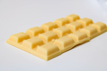 cracked white chocolate bar isolated on white