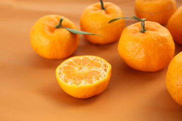 raw fresh tangerine oranges on a color background