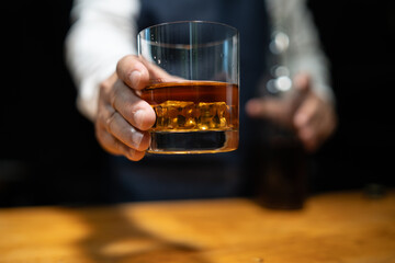 Barman pouring whiskey whiskey glass..