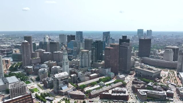 Wide drone shot of Boston's skyscraper skyline on a nice day.