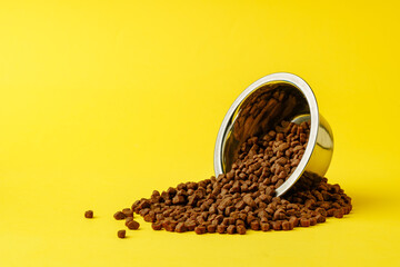 Cat food on yellow background studio shot