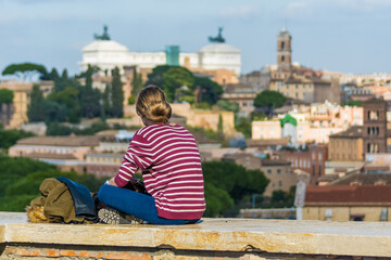 Fototapeta na wymiar Girl looking at a view of Rome, Italy