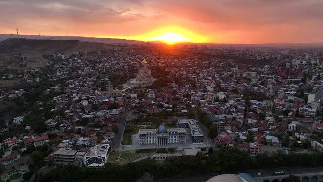 Tbilisi, Georgia. Scenic aerial view at twilight Of Famous Landmarks In Sunrise. Cityscape. Overview of the Kura (Mtkvari) River in Old Town, Tbilisi city central park and Bridge of Peace