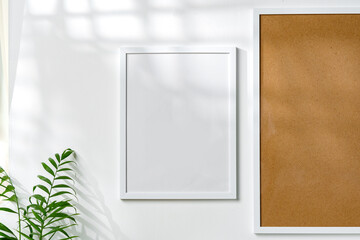 Cork board and blank frame hanging on the wall