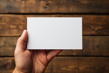 a person holding a business card mockup. plain white card