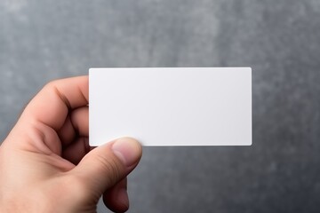 Fototapeta premium a person holding a small business card mockup