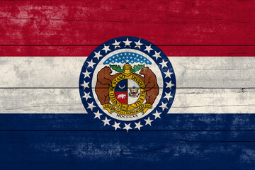 Missouri State flag on a wooden surface. Banner of the grunge Missouri State flag.