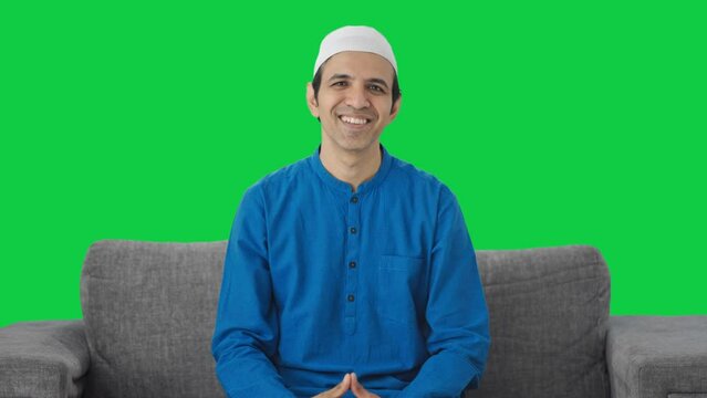 Happy Muslim man doing Adaab and greeting Green screen