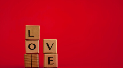 Spelling "LOVE ", in wooden blocks, red background