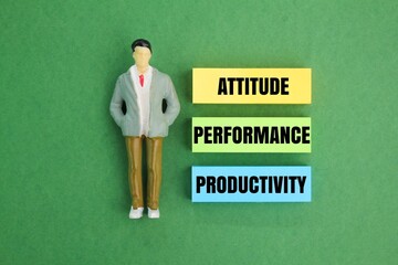 miniature people and colored paper with the words attitude, performance, productivity. the concept...