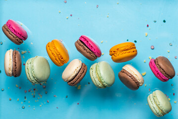 Set of flying colorful macaroons on blue background