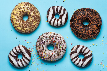 Several different donuts on blue background