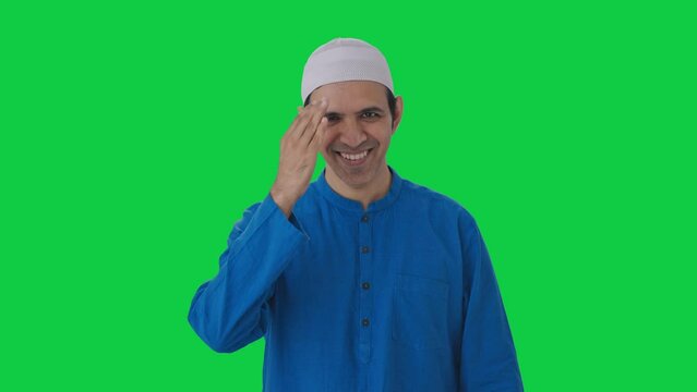 Happy Muslim man doing Adaab and greetings Green screen