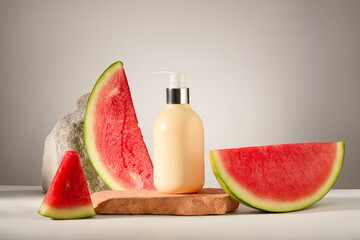 Cosmetics pump bottle mockup for design decorated with juicy watermelon slices and brick podiums on...