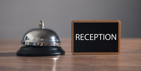 Service bell with a Reception word on the table.