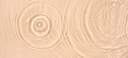 Fototapeta na wymiar water texture ripples wave clean transparent water abstract background in beige color