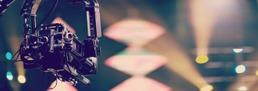 TV camera on a crane at a football match or concert. Close-up live video broadcast camera