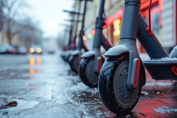 Foto op Plexiglas electric scooters in a parking lot in the city in winter close-up, perspective © Александр Довянский