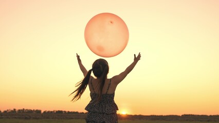 little girl daughter holding balloon sunset, childhood dream flying sky, happy family, child smile,...