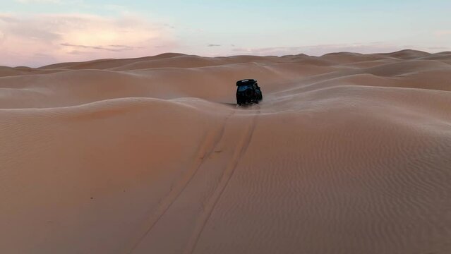 The drone is following a black car driving through the desert in Tunisia Aerial Footage 4K