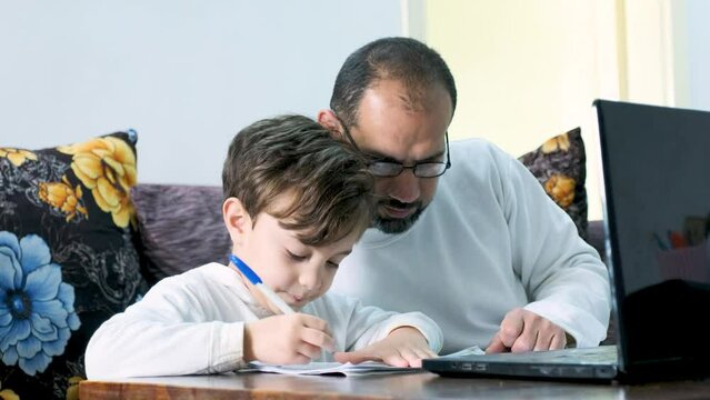 Arabic kid using laptop for learning from home