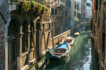 Fototapeta na wymiar A narrow canal street in Venice, Italy