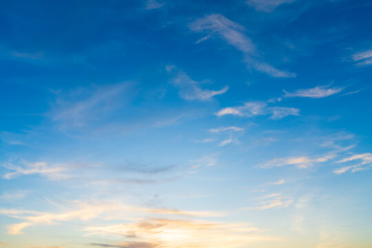 Twilight blue bright and orange yellow dramatic sunset sky in countryside or beach colorful cloudscape texture with white clouds air background.