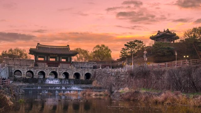 Time lapse, Banghwasuryujeong and Dongbukru in Hwaseong, Suwon with a beautiful sunset. Zoom out