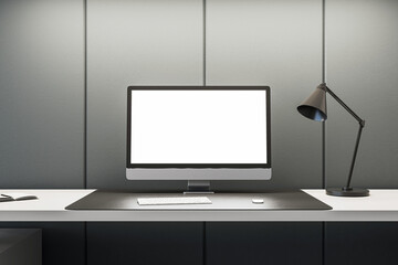 Stylish workspace with computer and desk lamp on gray wall background. Office simplicity concept. 3D Rendering