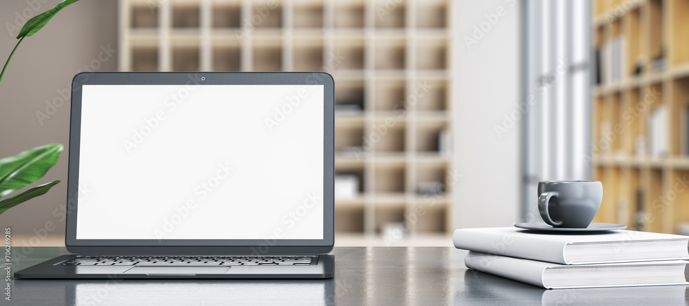 Aufkleber contemporary wide designer office desktop with empty white mock up laptop screen, coffee cup on stac