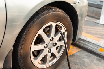 Fill Air station service for vehicle tires. Checking air pressure car wheels maintenance and safety