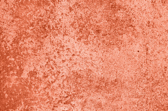 background, texture of concrete and stone in the color of 2024 peach fuzz. High quality photo