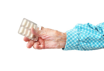 95 year old woman holding pills in hand, isolated on white background.Rheumatoid polyarthritis of the hands. - obrazy, fototapety, plakaty