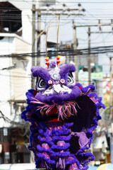 Chinese lion dance show on street in the Chinese New Year festival.Chinese lion costume used during Chinese New Year celebration in China town.Holidays and celebrations concept. Selective focus.