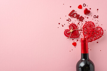 Top-down view of Valentine's allure. Wine bottle, heart-shaped confetti, and themed decor adorn a...