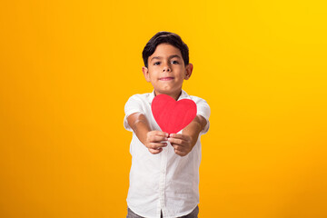 Kid boy holding paper heart. Love and valentine day and gratitude concept