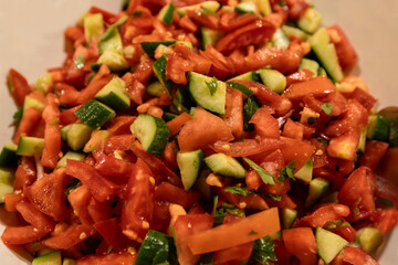 Homemade Mediterranean Cucumber Tomato Salad in a Bowl, side view. Close-up.