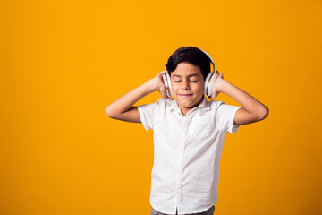 Kid boy with headphone listening to a music. Leisure and entertainment concept