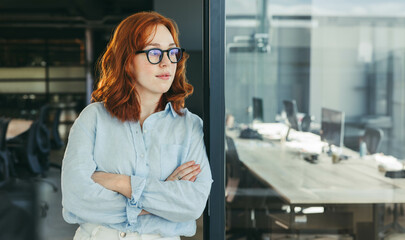 Confident businesswoman in office, thinking about work