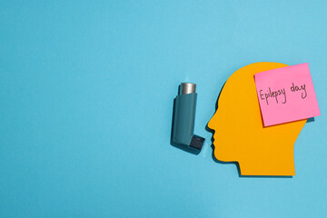 Epilepsy day concept, human paper head with inhaler