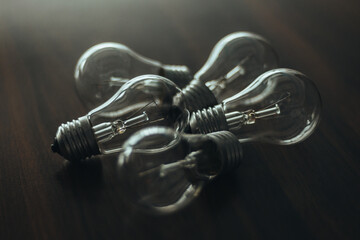 Light bulbs on the table. Wooden table. Background image. Lots of non-working light bulbs. No...
