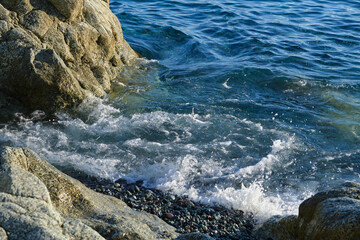 Clear amazing azure colour sea water with granite rocks in beach, Italy. Aerial view of sea waves...