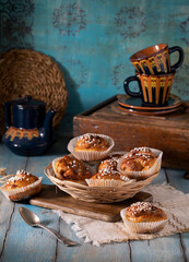 Fresh homemade cinnamon muffins on blue wooden table