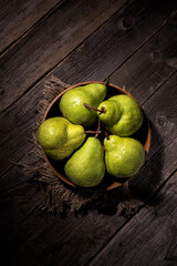 Still life of pears on a plate on a wooden table top view