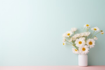 White daisies in a modern white vase on a pastel pink surface, with ample copy space for a serene message