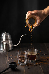 Process of hand pouring coffee into a cup