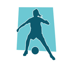 Silhouette of a female soccer player kicking a ball. Silhouette of a football player woman in action pose.