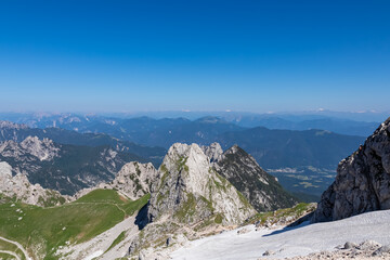 Scenic view of high alpine Mangart road (Mangartska cesta) seen from Mangart Saddle (Mangartsko sedlo) in untamed Julian Alps, border Slovenia Italy, Europe. Hiking wanderlust in Friuli Venezia Giulia